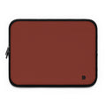 A rectangular laptop sleeve in a muted terracotta red color with black trim and a small black monogram logo in the bottom right corner, shown on a plain white background.