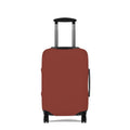 A hard-shell suitcase fitted with a  protective cover in a muted terracotta or rust red color. 