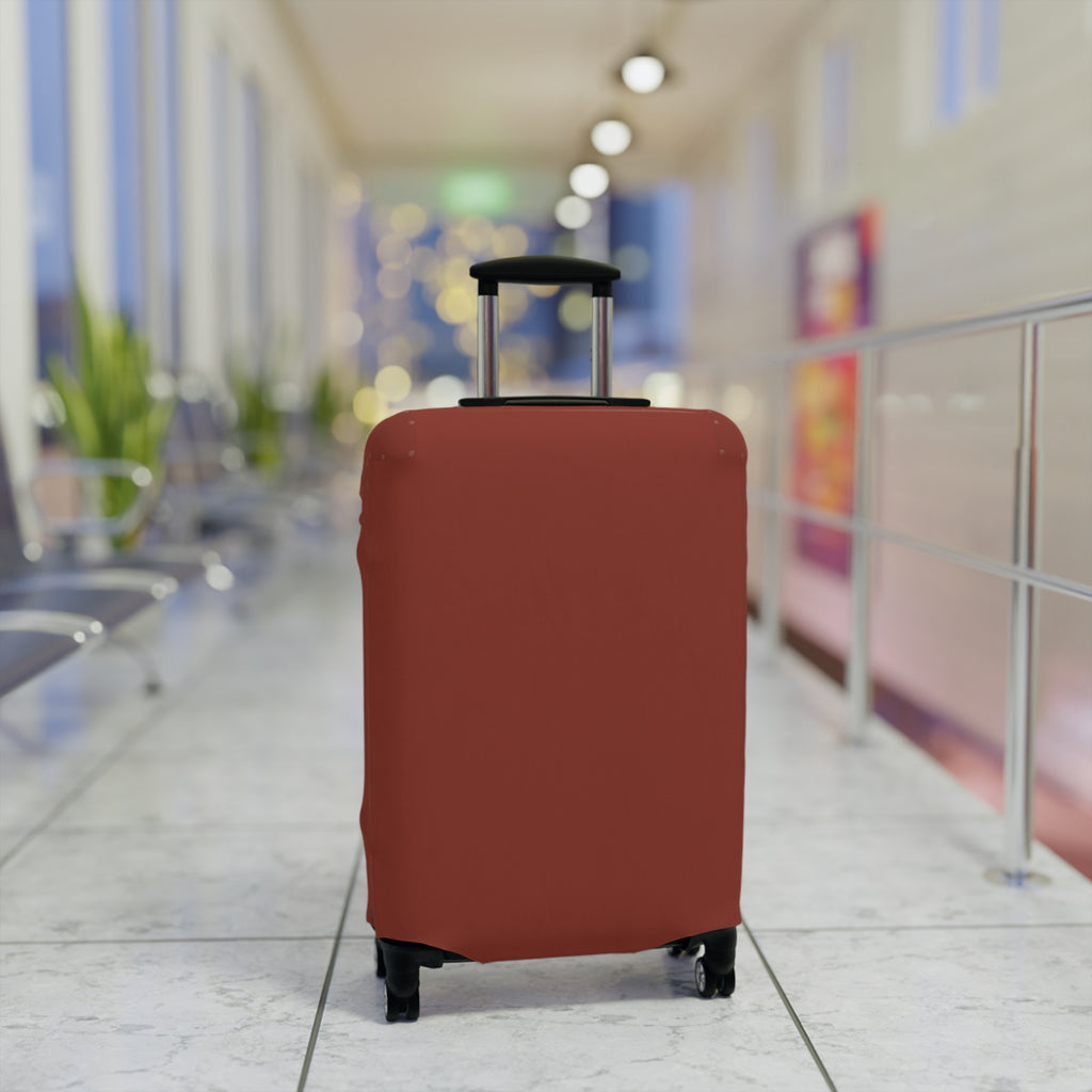 A terracotta red elastic luggage cover fitted on a rolling suitcase, standing upright in a brightly lit, blurred airport terminal corridor.