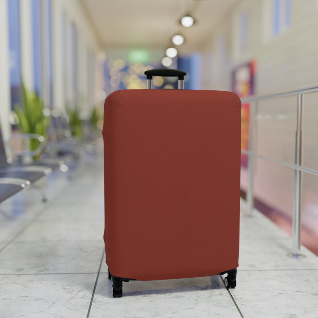A terracotta red or rust-colored luggage suitcase cover fitted on a rolling suitcase, standing in a blurred airport terminal hallway.