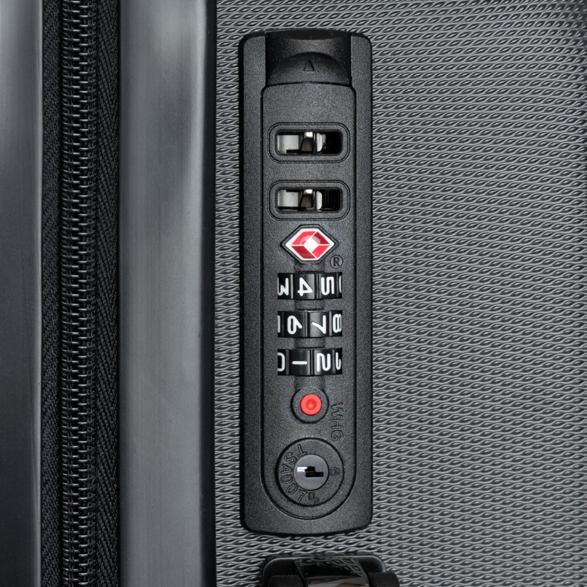 Close-up of a suitcase's combination lock on a textured gray surface