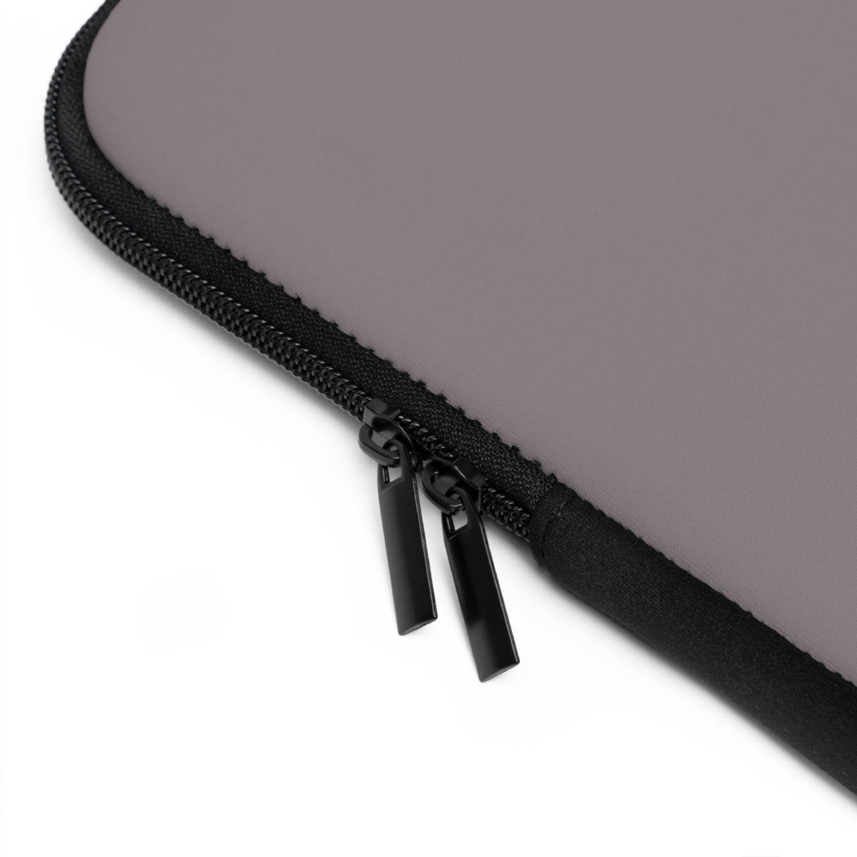 Close-up of a black zipper on a gray laptop sleeve