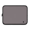 A rectangular laptop sleeve in a muted gray color with black trim and a small black monogram logo in the bottom right corner, shown on a plain white background.
