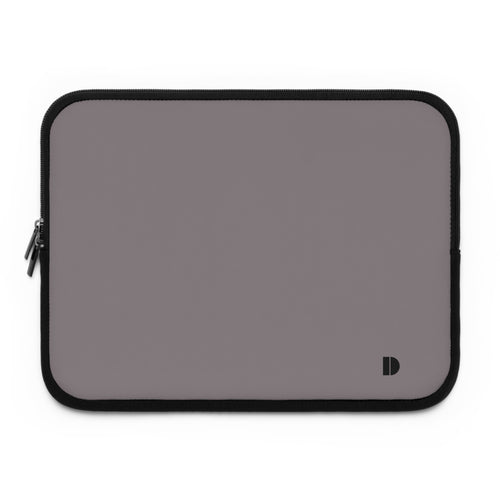 A rectangular laptop sleeve in a muted gray color with black trim and a small black monogram logo in the bottom right corner, shown on a plain white background.