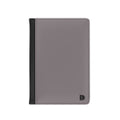 A minimalist passport cover or document holder in a muted grayi with a black spine band and a small black monogram logo in the bottom right corner, shown on a plain white background.