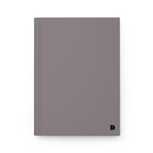 A minimalist hardcover notebook in a muted taupe-gray color, featuring a small black stylized 'D' logo in the bottom right corner, set against a clean white background.