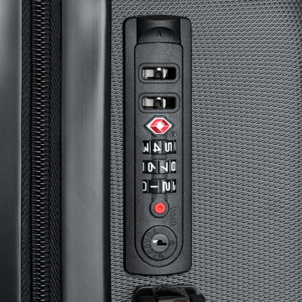 Close-up of a suitcase's combination lock on a textured gray surface