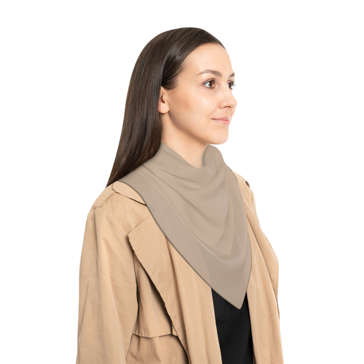 Woman wearing a beige coat with a sheer fabric beige scarf on a white background