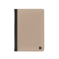 A minimalist passport cover or document holder in beige faux leather with a black spine strip and a small black monogram logo in the bottom right corner, shown on a plain white background.