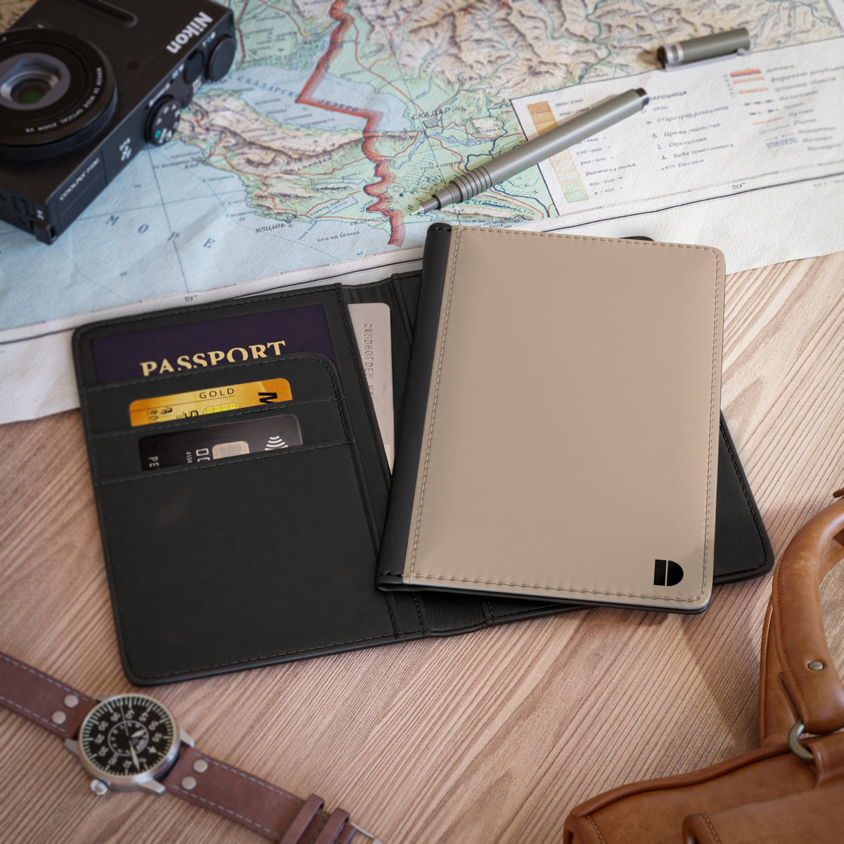 Beige faux leather passport holder and passport on a map and camera background