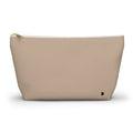 A beige zippered pouch with a small black monogram logo on the bottom right corner, photographed on a clean white background.