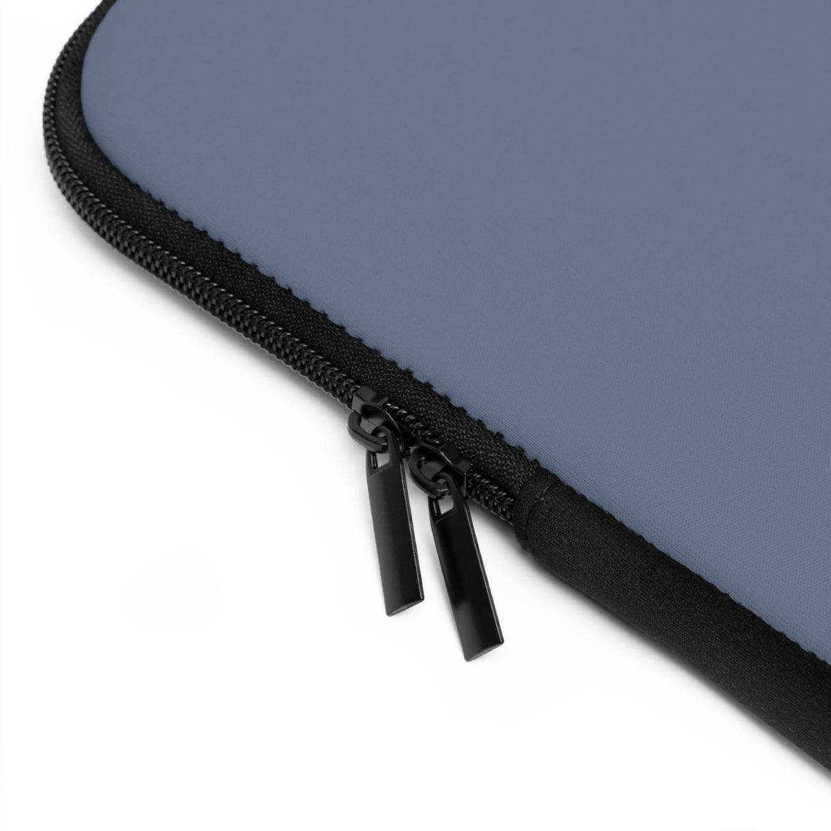 Close-up of a black zipper on a blue-gray laptop sleeve