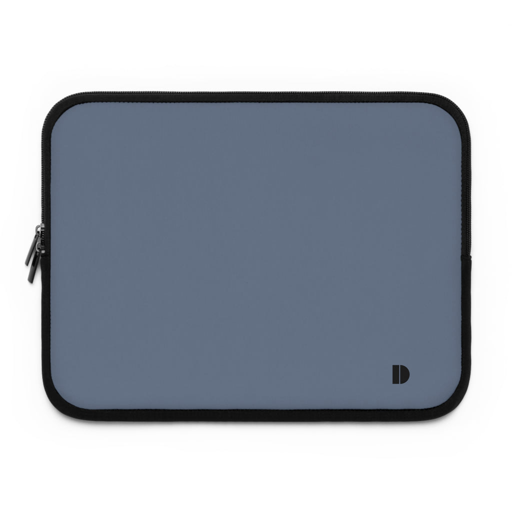 A slate blue laptop sleeve with black trim and a small black monogram logo in the bottom right corner, shown on a plain white background.