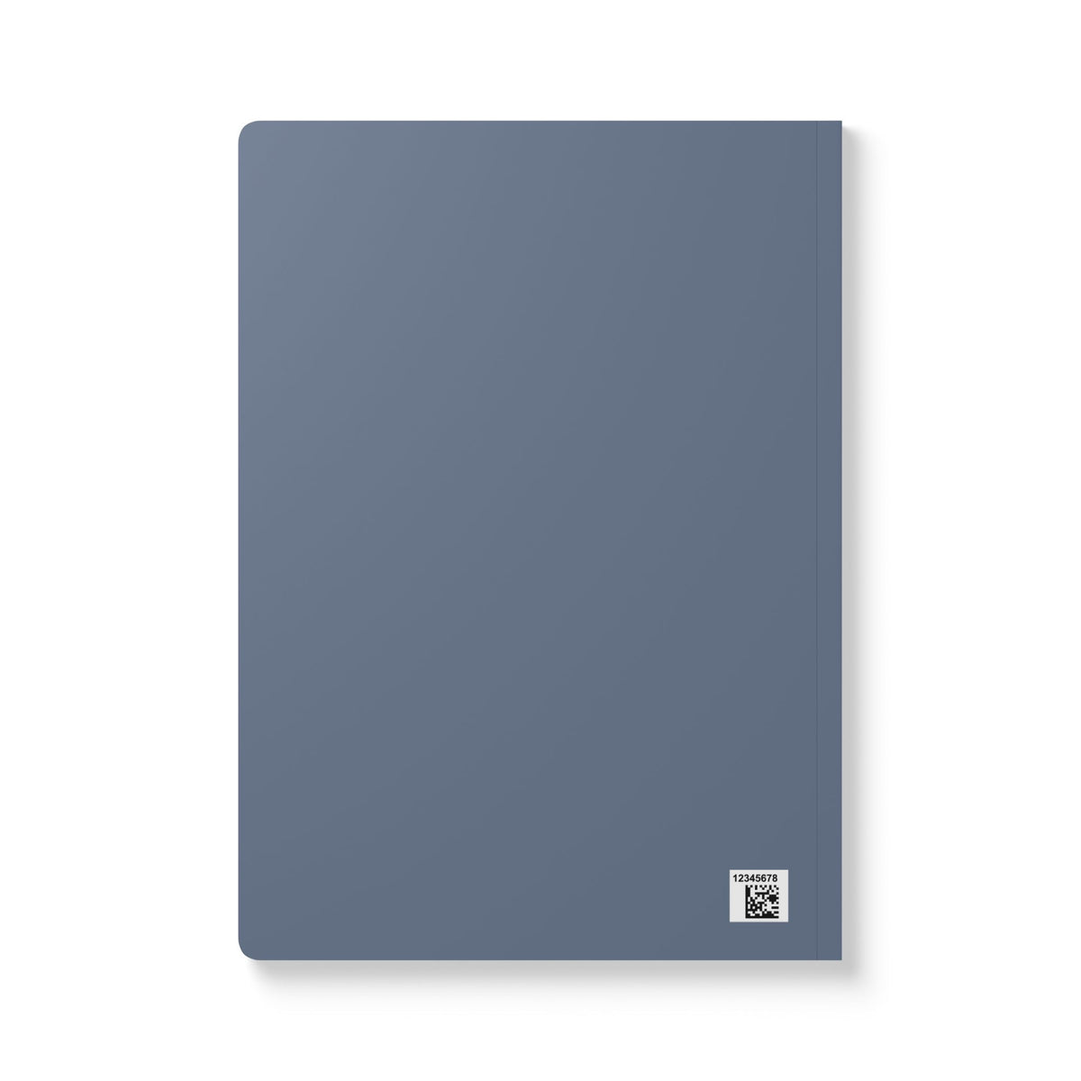 A minimalist softcover notebook in a muted slate blue color, shown from a slight angle on a clean white background with a soft drop shadow.