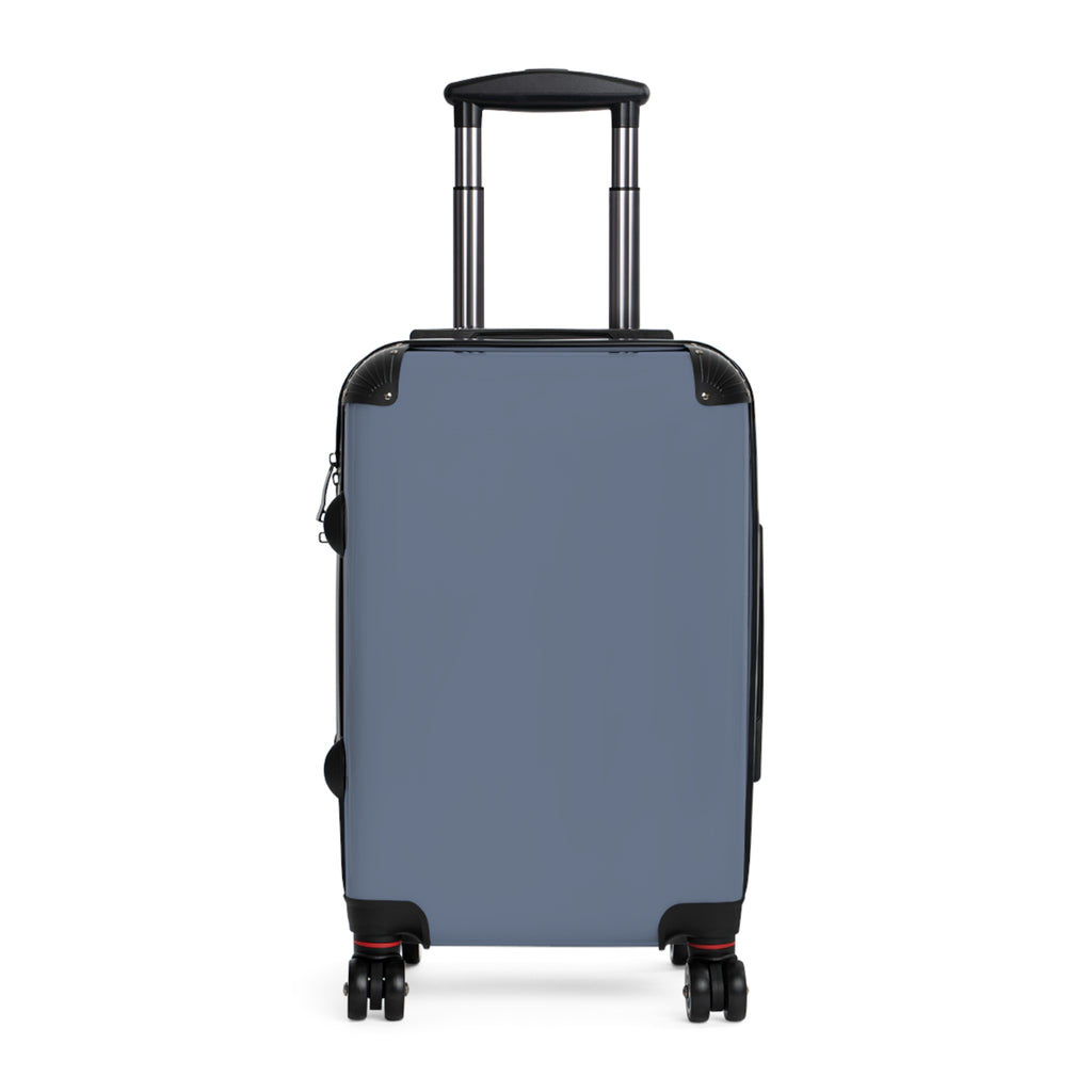 A hard-shell carry-on suitcase in muted blue, featuring an extended telescoping handle and four spinner wheels, shown against a plain white background.
