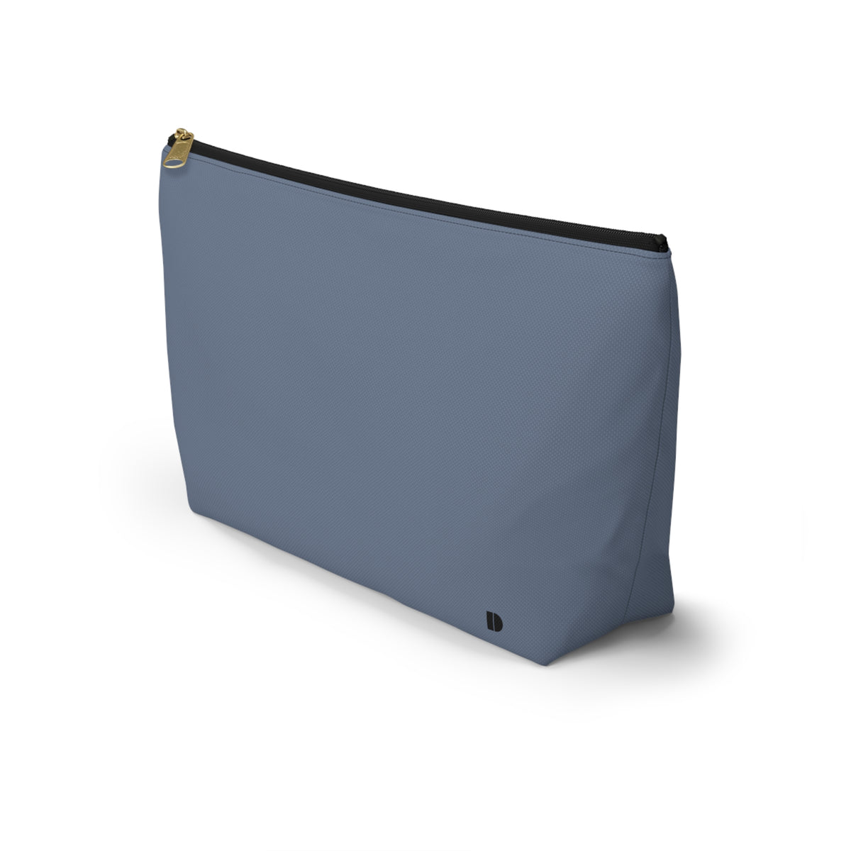 A dusty blue zippered pouch with a small black monogram logo on the bottom right corner and a gold zipper pull, shown on a plain white background.