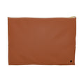 A rectangular rust-colored pouch with a gold zipper and a small black monogram logo in the bottom right corner, set against a plain white background.