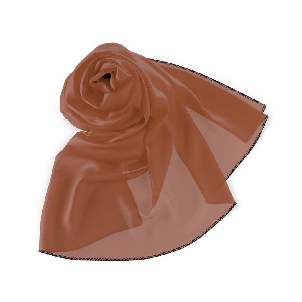 A sheer fabric rust-colored scarf folded neatly on a white background