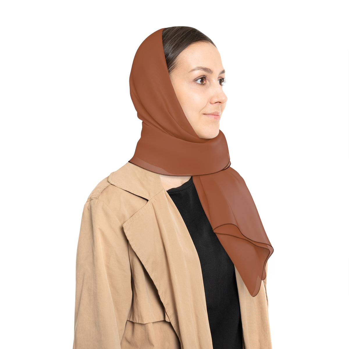 A woman wearing a rust-brown wrap as a head scarf and a beige trench coat over a black top, shown in profile against a solid white background.