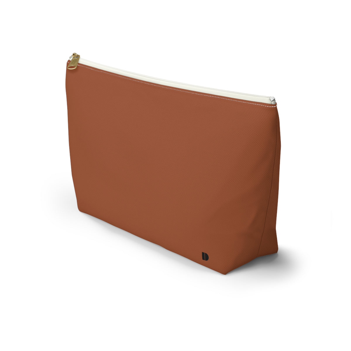 A rust-colored cosmetic pouch with a gold zipper and a small black monogram logo on the bottom right, set against a plain white background.