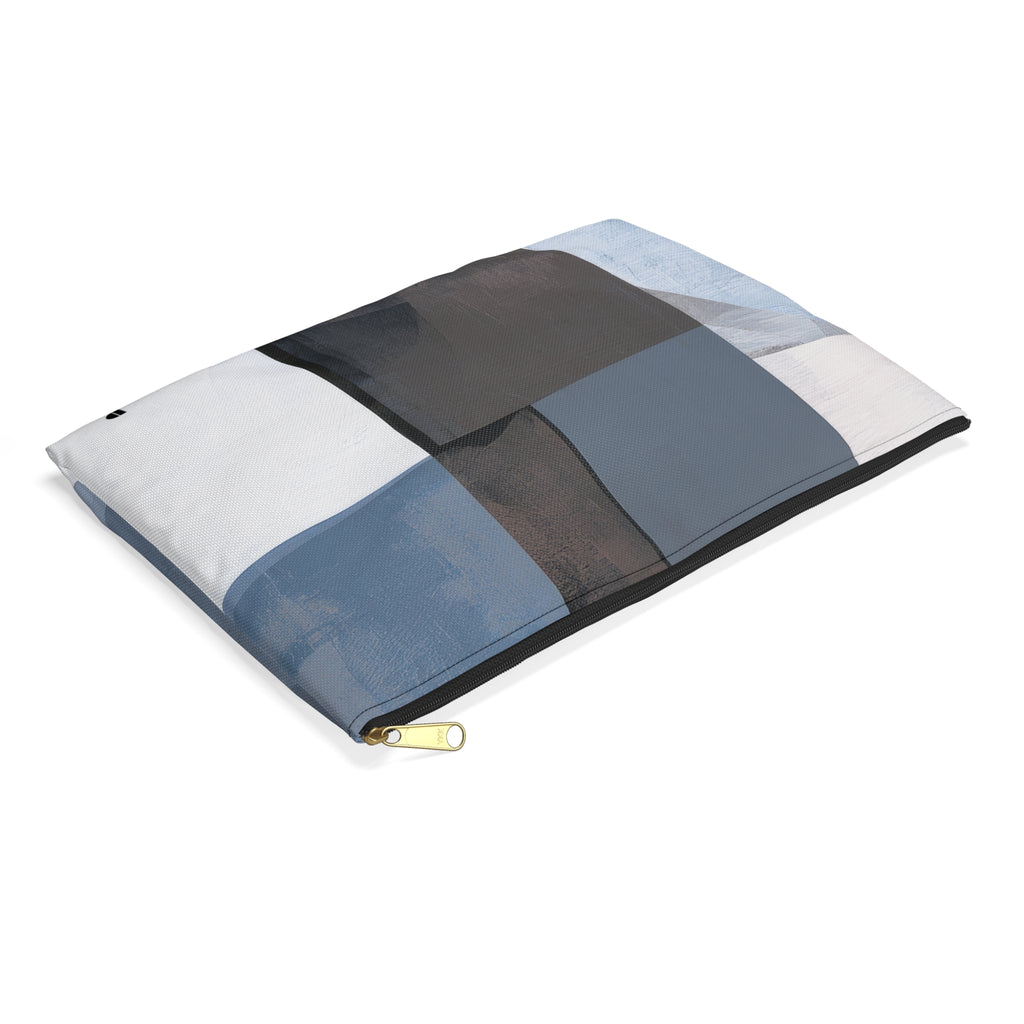 A rectangular zippered pouch with a patchwork design in shades of blue, gray, black, and white, shown on a clean white background.