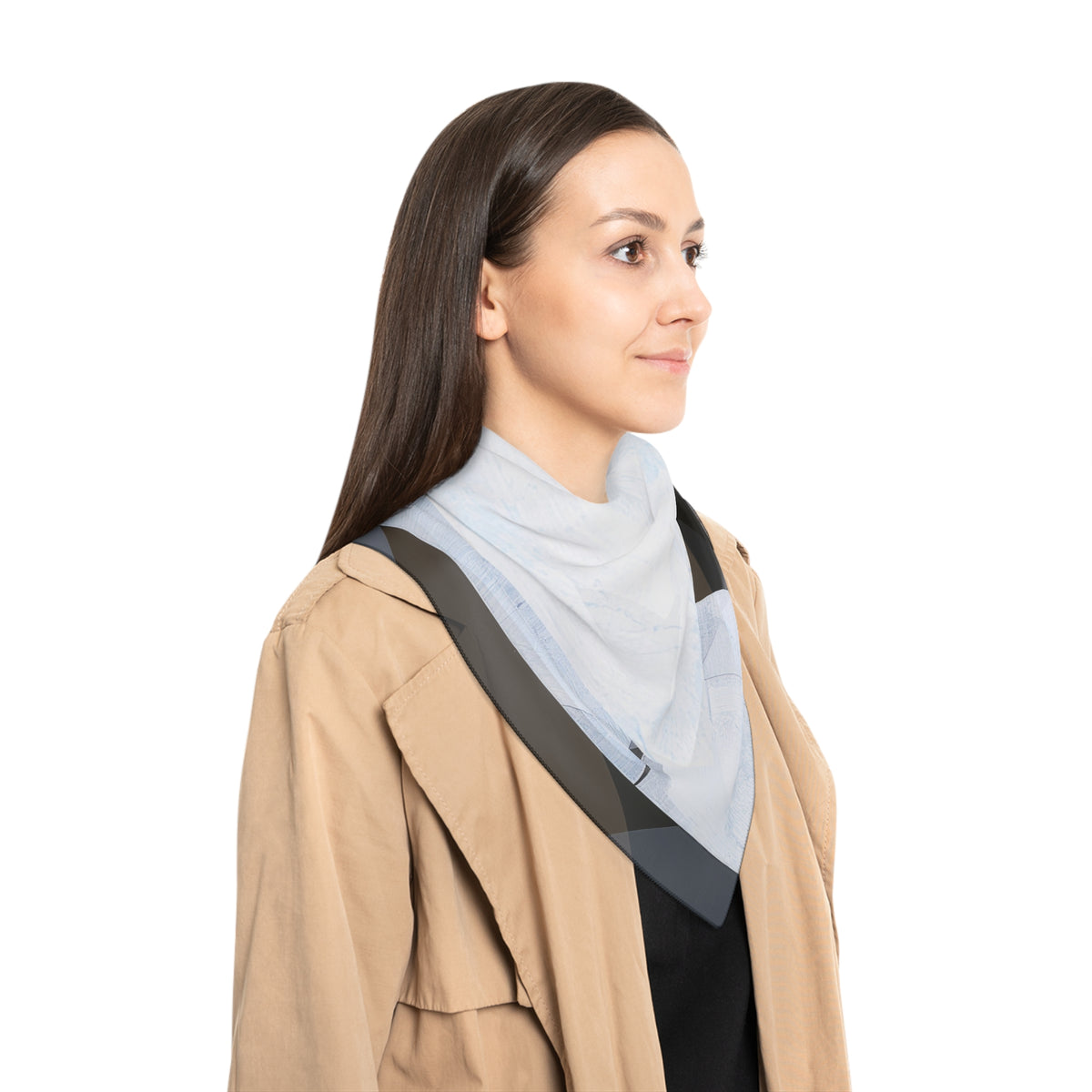 A woman in profile wearing a light blue high-neck knit top with a wide blue, white and gray shoulder wrap, styled with a beige trench coat, against a solid white background.