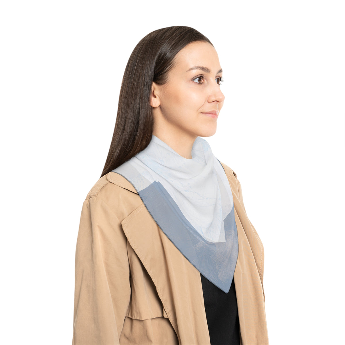 A woman shown in profile wearing a light blue triangular neck scarf layered over a beige jacket, against a solid white background.