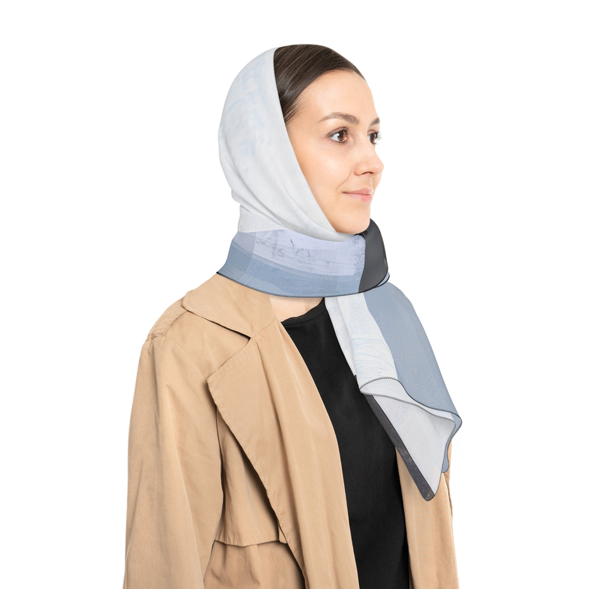 A woman wearing a light blue and gray patterned scarf as a head scarf, styled with a beige trench coat over a black top, shown from a side profile against a solid white background.