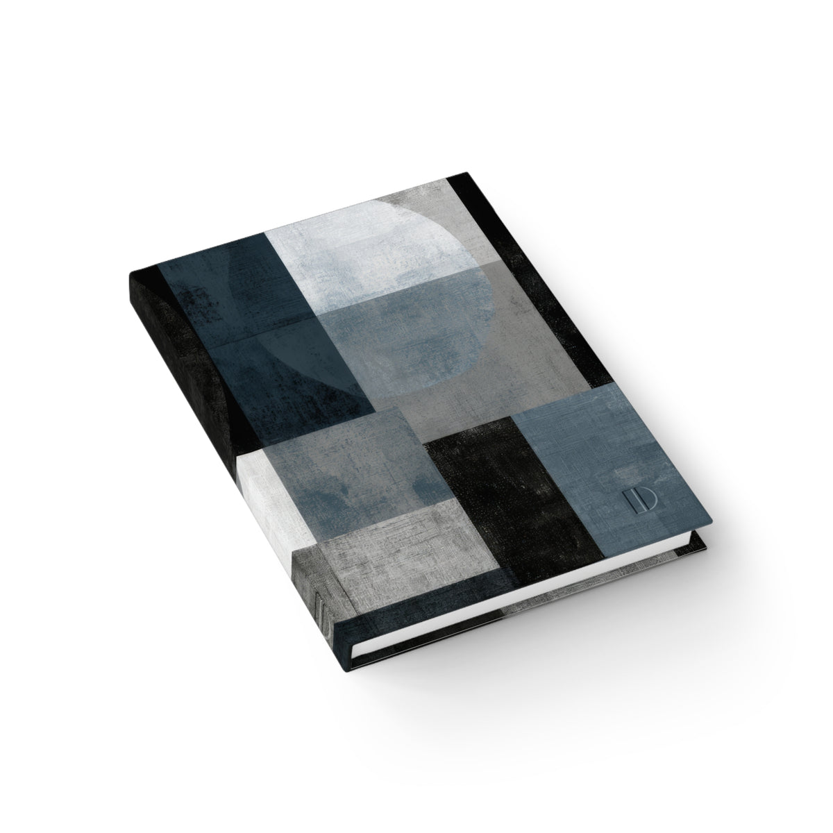 An angled overhead view of the abstract geometric hardcover journal by The Cultivated Desk, showcasing the sturdy spine construction, continuous patterned cover, and high-quality paper book block.