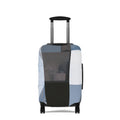 A hard-shell suitcase with an extended telescoping handle and four wheels, covered in a patchwork luggage sleeve featuring blocks of light blue, white, black, and gray, shown against a plain white background.