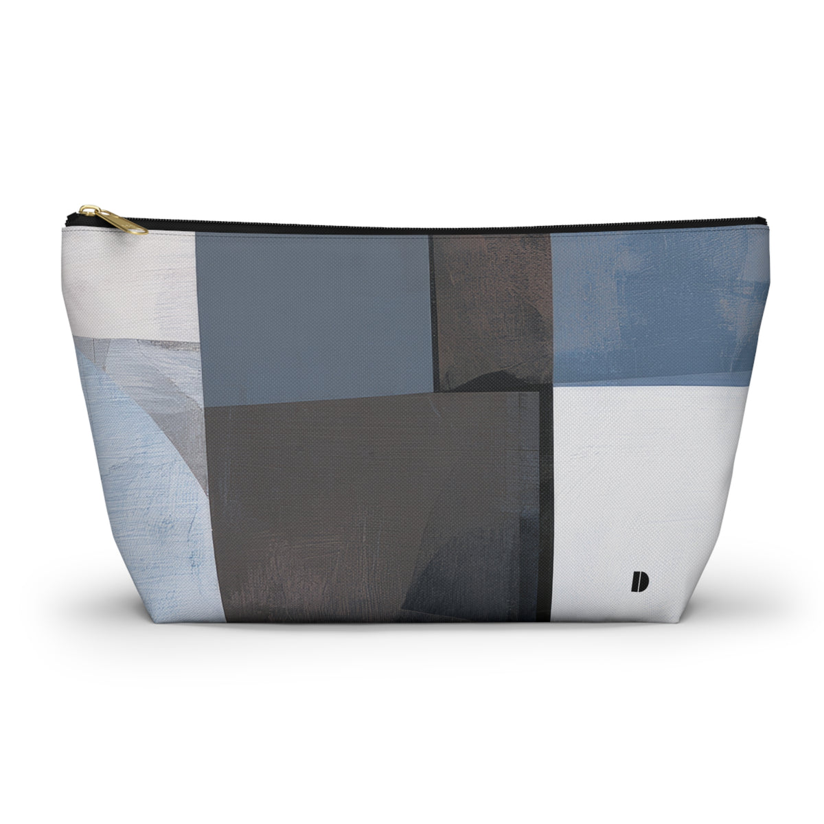 A rectangular zippered pouch with an abstract geometric patchwork pattern in shades of blue, gray, white, and charcoal, featuring a gold zipper pull and a small black logo on the bottom right.