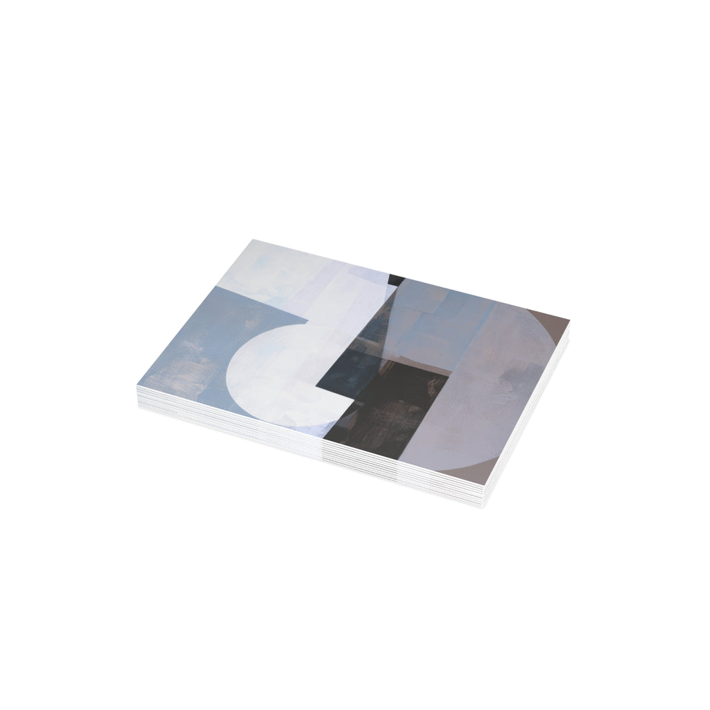 A stack of 10  rectangular gratitude cards with an abstract geometric design in shades of blue, white, gray, and black, photographed on a plain white background.