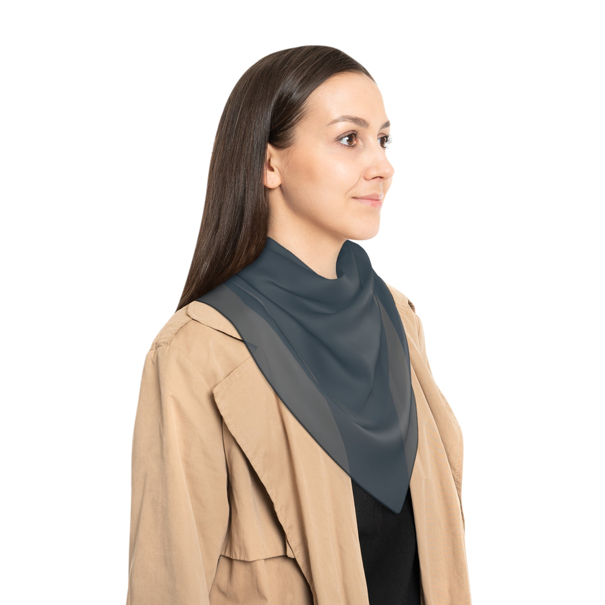 Woman wearing a beige coat with a blue-gray neck scarf on a white background