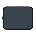 A dark slate blue laptop sleeve with black trim and a small black monogram logo in the bottom right corner, shown on a plain white background.