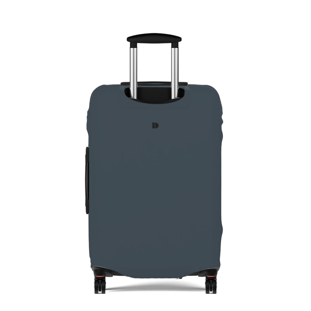 A dark slate blue luggage cover fitted on a rolling suitcase, shown from the front against a plain white background. The cover features a small black monogram logo near the top center.