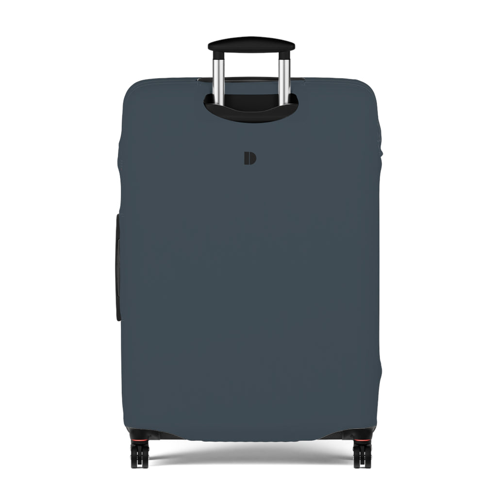 A dark slate blue luggage cover fitted on a hard-shell suitcase, shown from the front against a plain white background. The cover features a small black monogram logo near the top center.