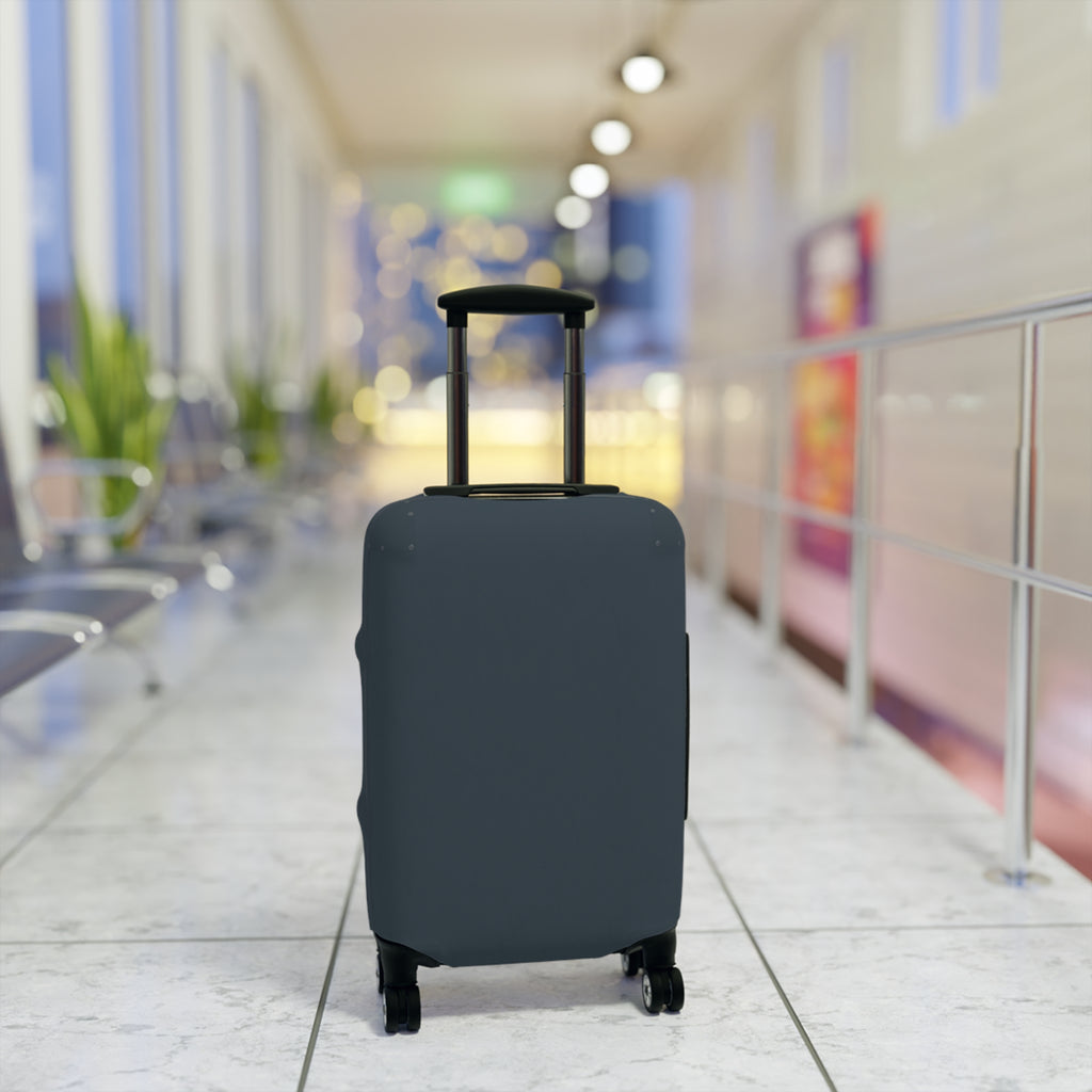 A dark slate blue or gray protective suitcase cover fitted on a rolling suitcase, standing in a blurred airport terminal hallway.