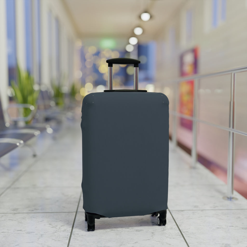 A dark slate blue or gray protective suitcase cover fitted on a rolling suitcase, standing in a blurred airport terminal hallway.