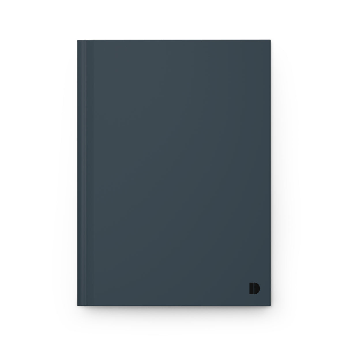 A minimalist hardcover notebook in a dark slate blue-gray color, featuring a small black monogram logo in the bottom right corner, set against a clean white background.