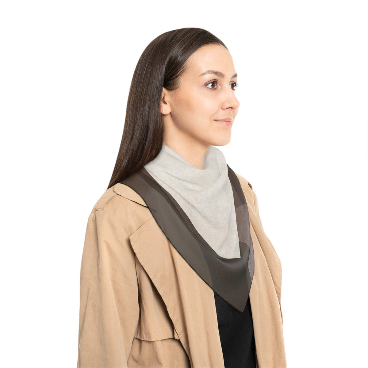A woman in profile wearing a beige trench coat over a light gray mock neck top and black top, with a dark brown sheer shoulder scarf draped across her shoulders, set against a plain white background.