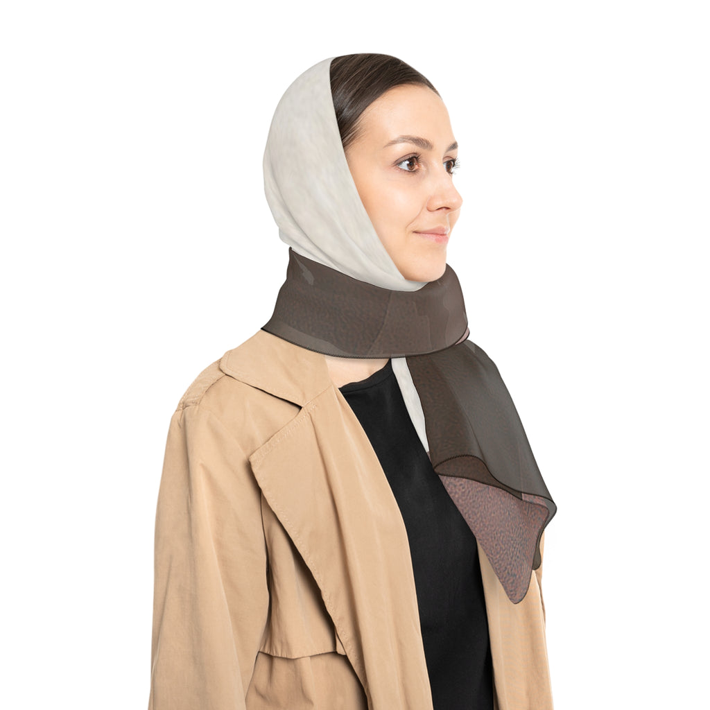 A woman wearing a large multi-colored scarf in brown tones, styled with a beige trench coat and black top, shown in profile against a solid white background.