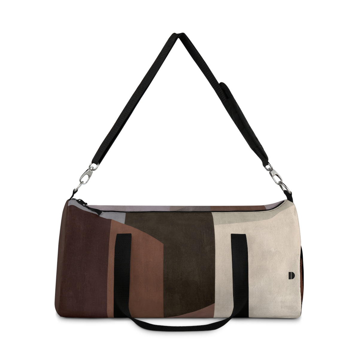 A duffle bag with an abstract geometric color-blocked pattern in brown, beige, and dark gray, featuring black straps and silver hardware, shown on a plain white background.