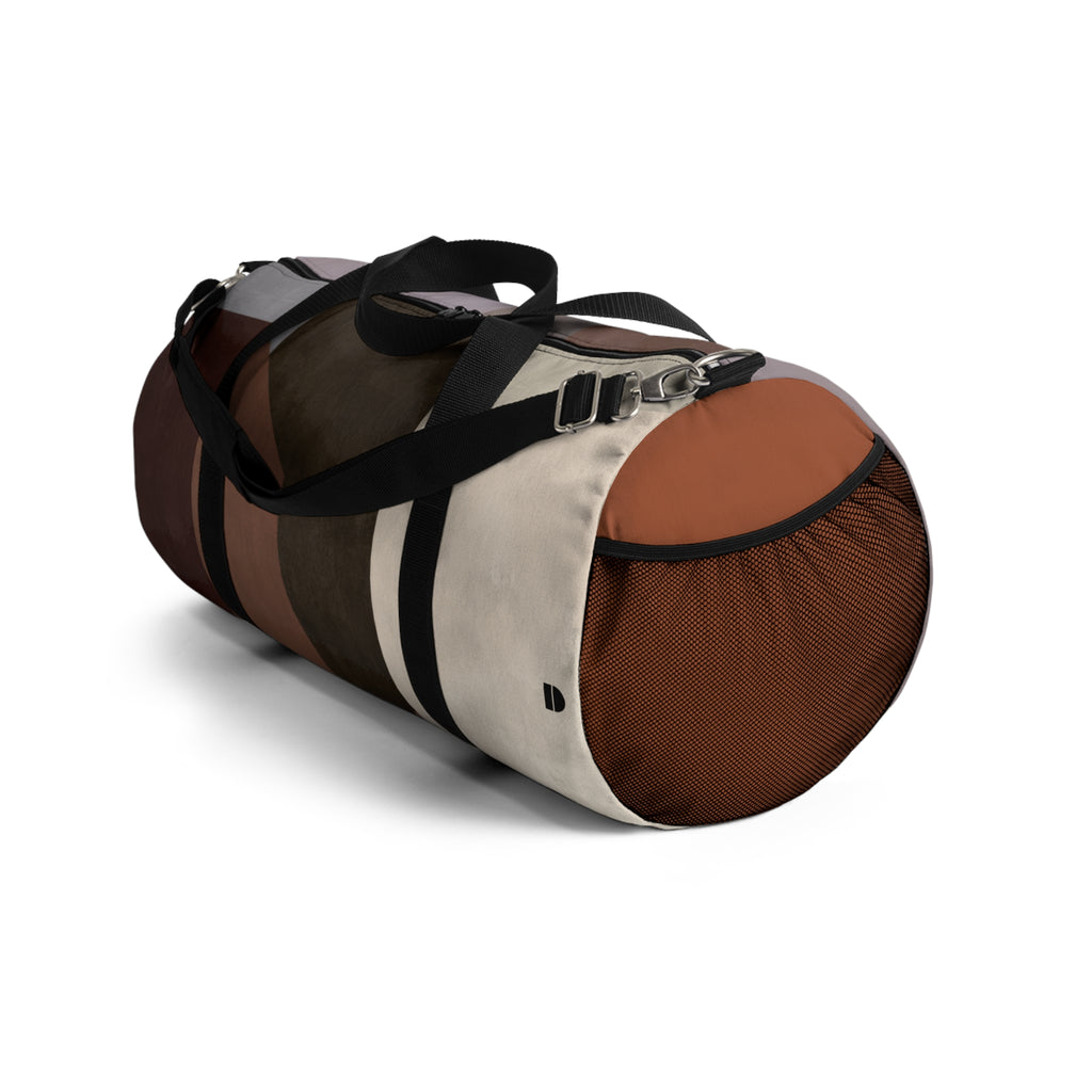 A cylindrical duffle bag with a color-blocked design in brown, beige, and black, featuring black handles and a black mesh side pocket, shown on a white background.