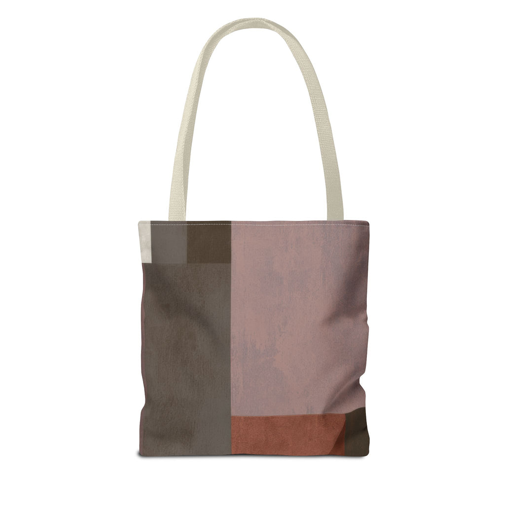A canvas tote bag with a modern abstract geometric block pattern in muted tones of dusty pink, taupe, brown, and terracotta, featuring off-white shoulder straps on a solid white background.