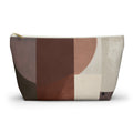 A zippered cosmetic pouch with an abstract geometric pattern in shades of brown, beige, and cream, featuring a gold zipper pull and small black logo on bottom right.