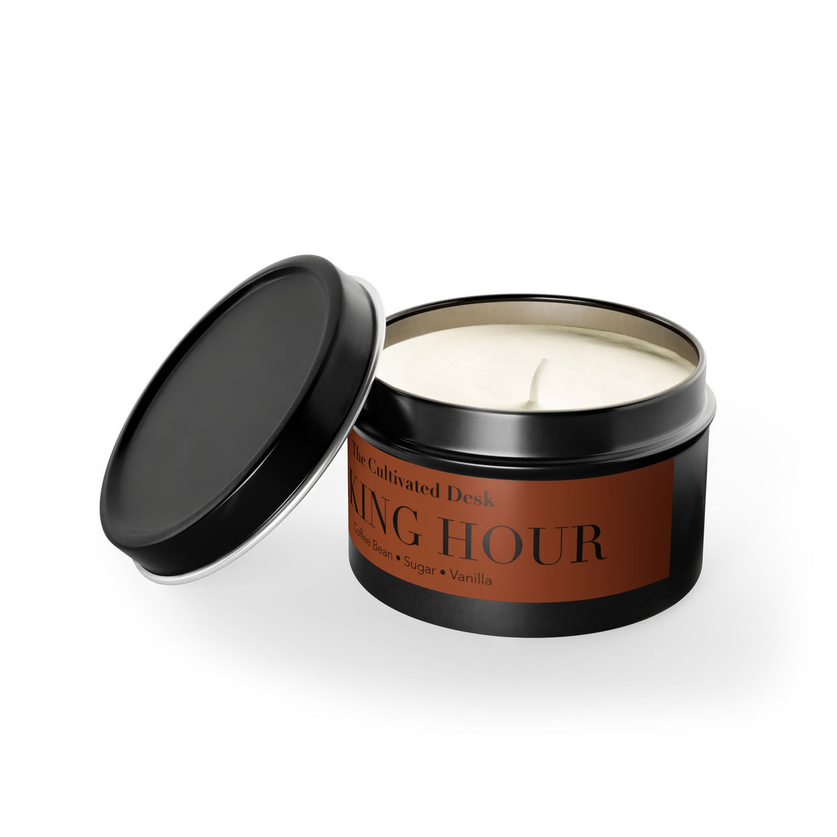 A black metal tin candle with its lid off, showing the white soy wax inside. The front label is brown with black text reading 'The Cultivated Desk' and 'WAKING HOUR'.